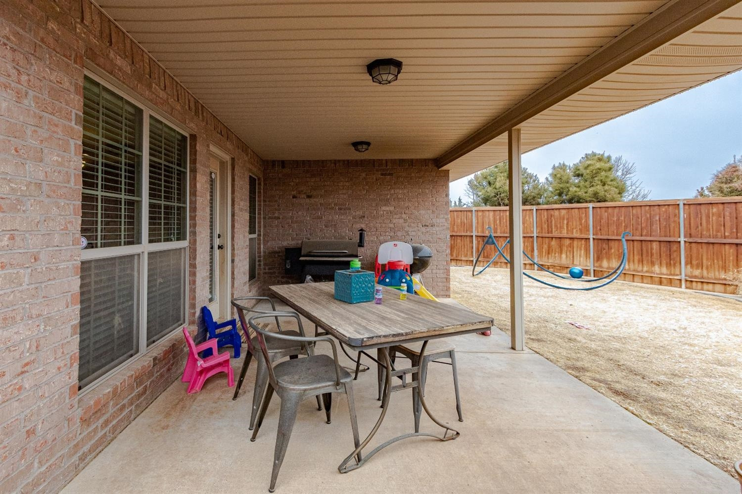 9301 Rochester Avenue Lubbock, TX 79424 - Photo 38 of 49 a view of a dining table and chairs in the patio