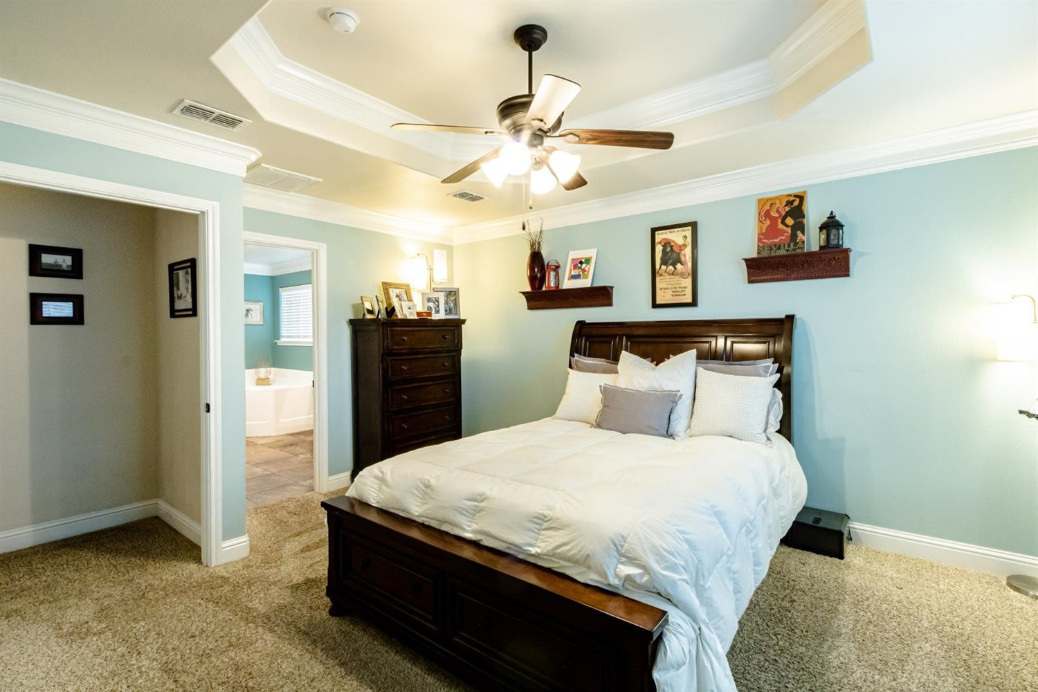 9301 Rochester Avenue Lubbock, TX 79424 - Photo 5 of 49 a bedroom with a bed and a chandelier
