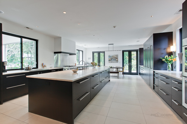 435 Thorne Lane Lake Forest, IL 60045 - Photo 14 of 42 a large kitchen with stainless steel appliances and white cabinets