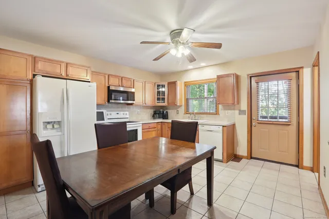 a view of a dining room with furniture and a window