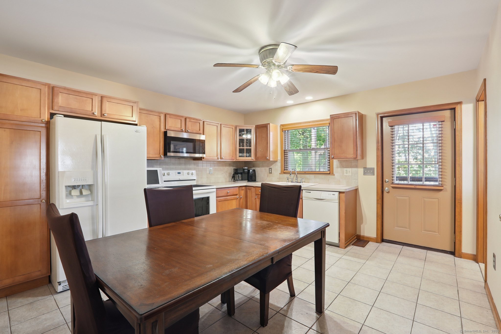 a view of a dining room with furniture and a window