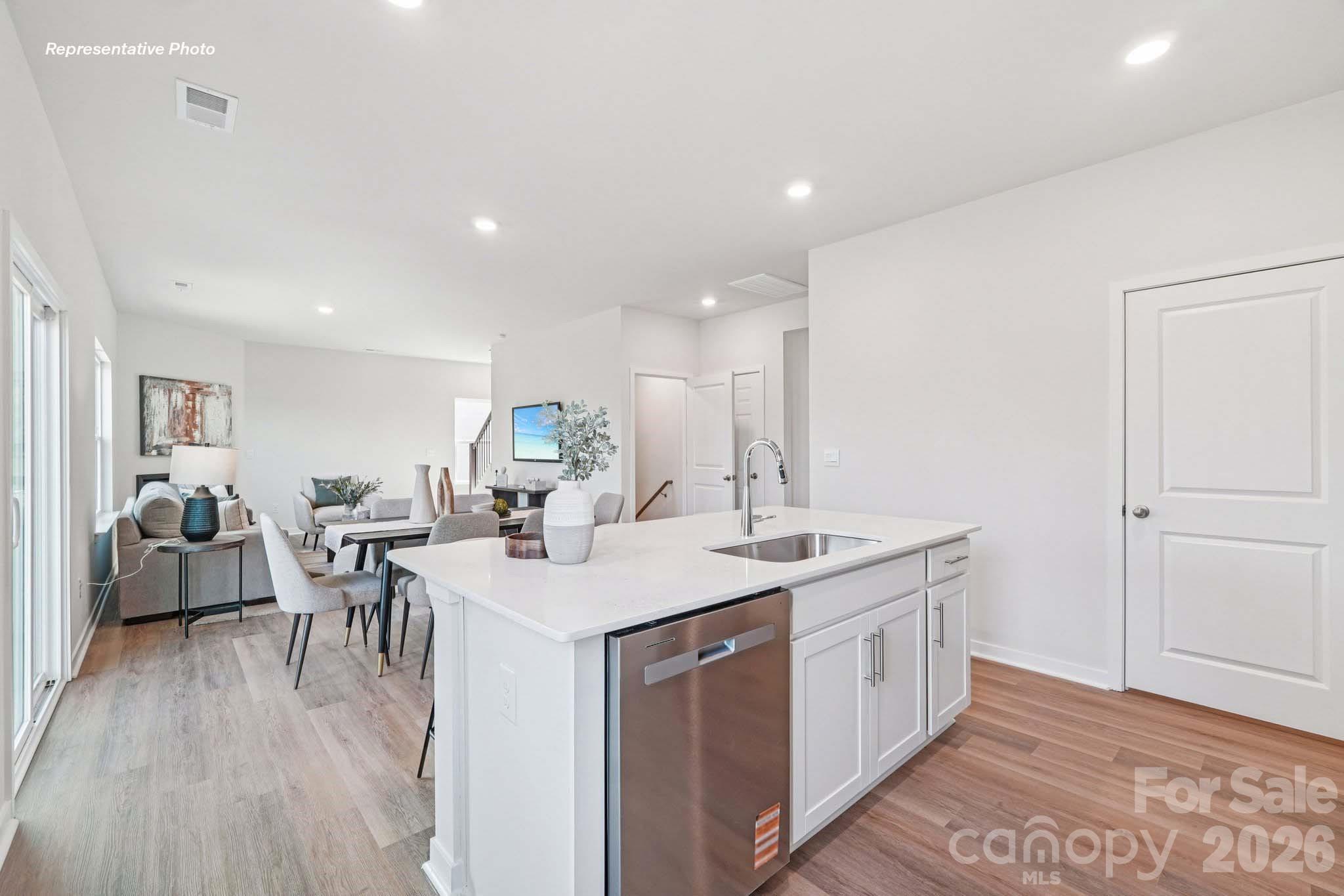 7600 Bainbridge Road Sherrills Ford, NC 28673 - Photo 11 of 39 a open kitchen with a sink dining table and chairs