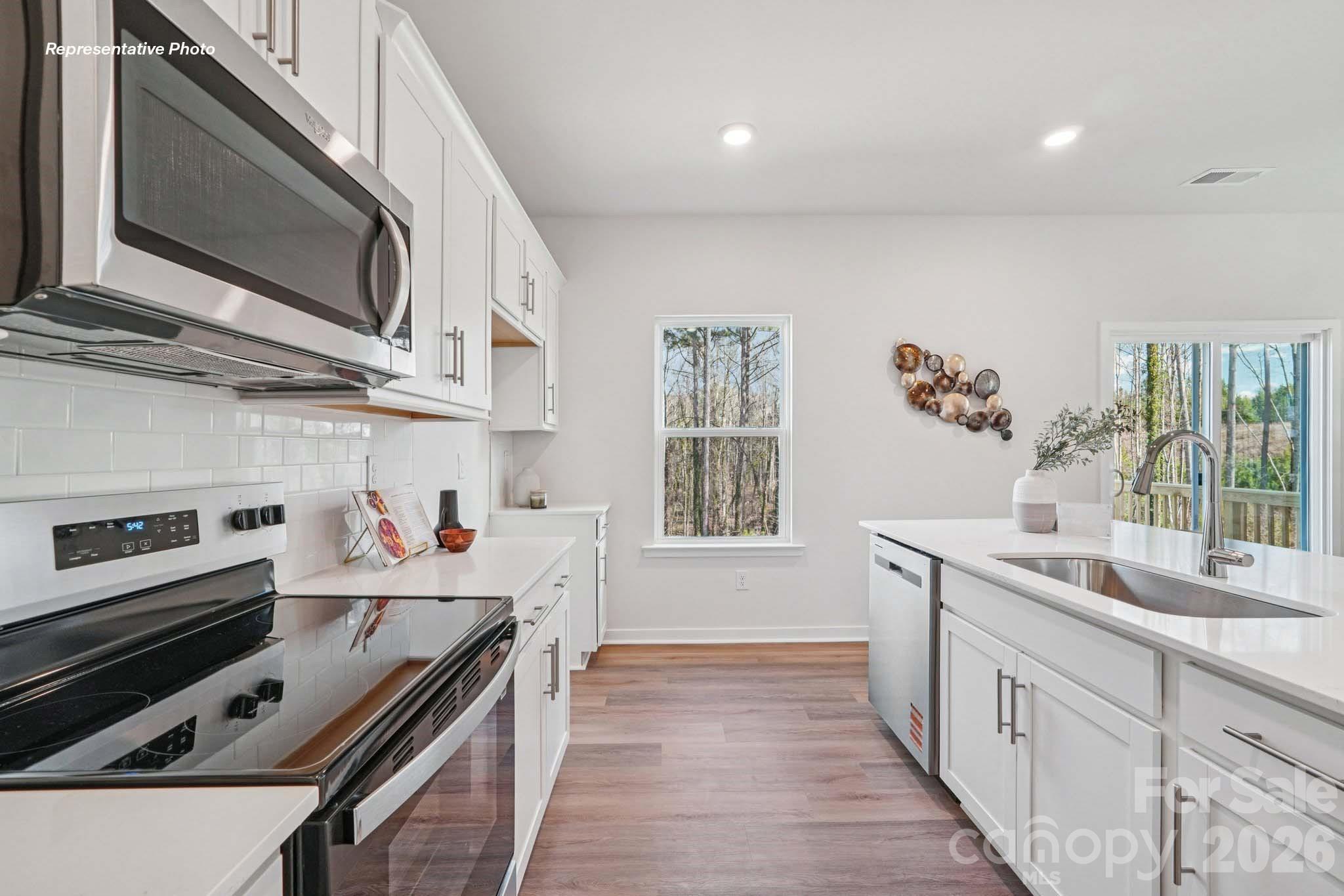 7600 Bainbridge Road Sherrills Ford, NC 28673 - Photo 12 of 39 a kitchen with stainless steel appliances a sink a stove and cabinets