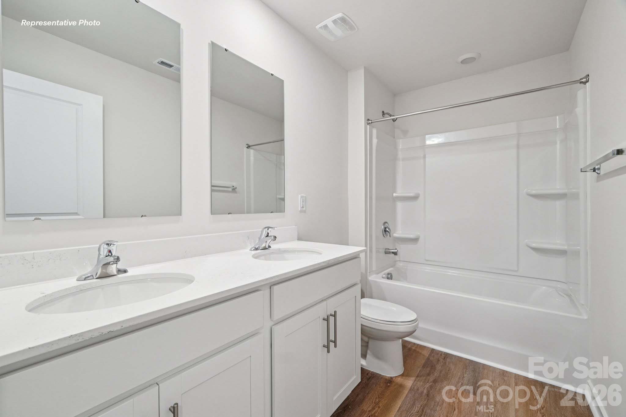 7600 Bainbridge Road Sherrills Ford, NC 28673 - Photo 23 of 39 a bathroom with a sink a toilet and a large mirror