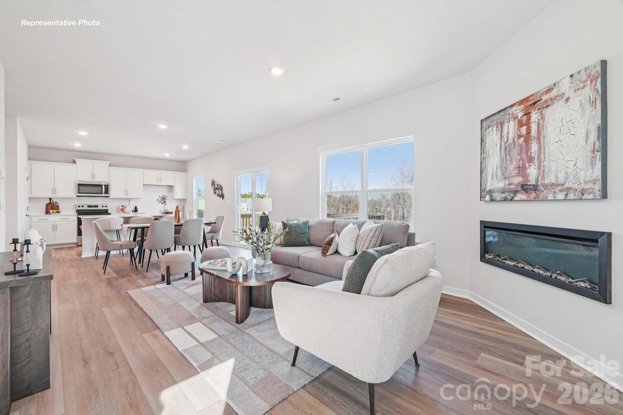 7600 Bainbridge Road Sherrills Ford, NC 28673 - Photo 5 of 39 a living room with furniture a fireplace and a large window