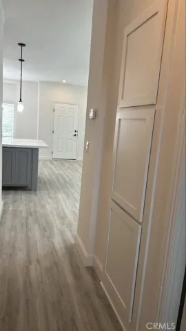 a view of a room with wooden floor