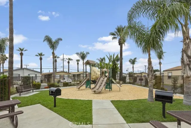 a view of a park with swings and slides