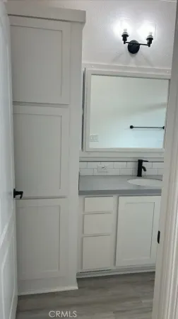 a view of white cabinets and a wooden floor