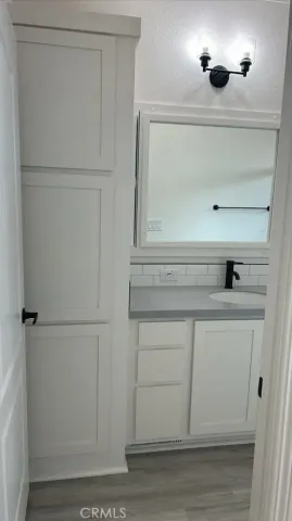 a view of white cabinets and a wooden floor