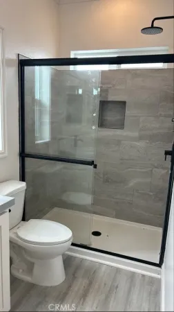 a white toilet next to a bathroom sink