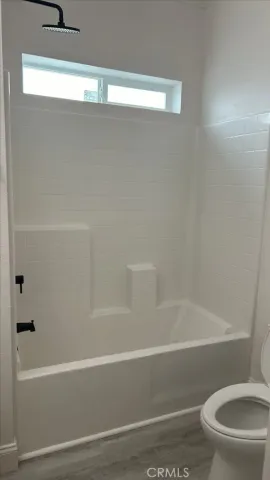 a bathroom with a toilet and a bathtub