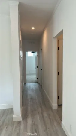 a view of a hallway with wooden floor