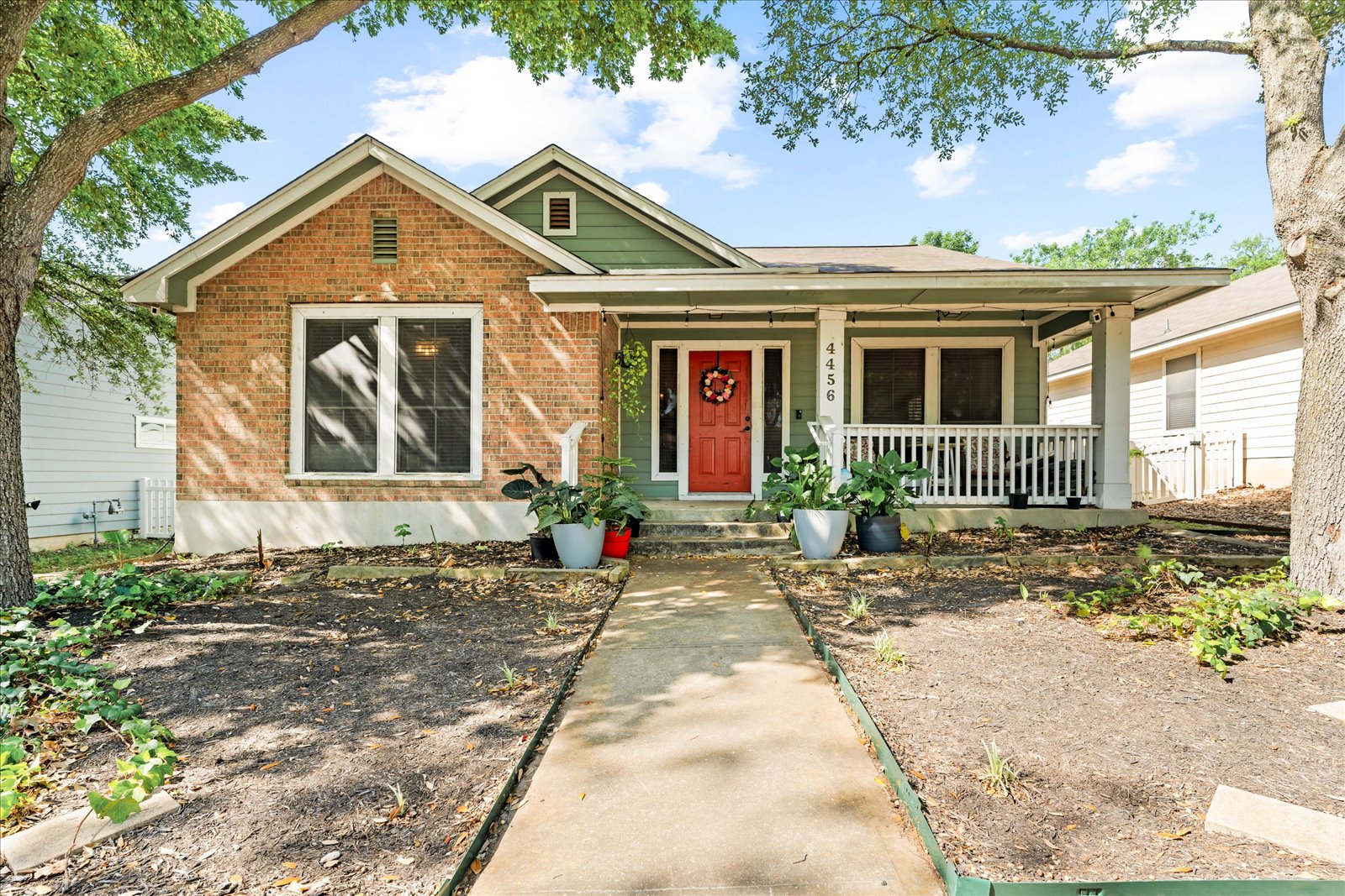 View of front of property with covered porch and brick siding