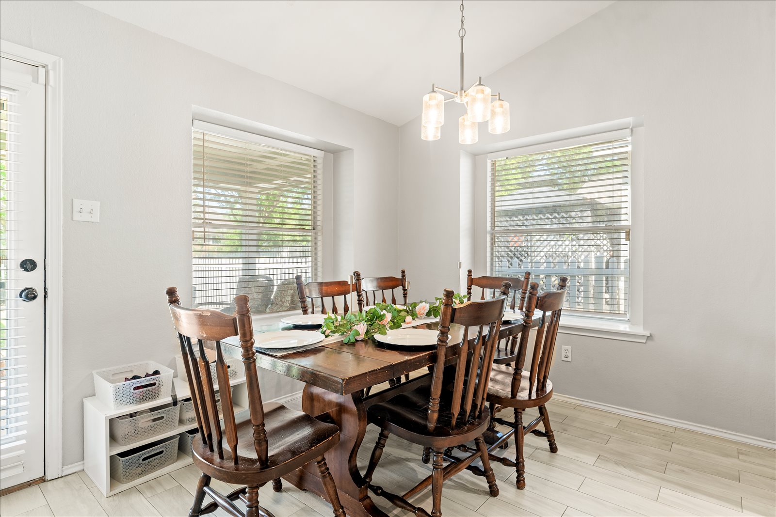 4456 Mather Kyle, TX 78640 - Photo 10 of 25 Dining area featuring vaulted ceiling, wood finish floors, and a chandelier