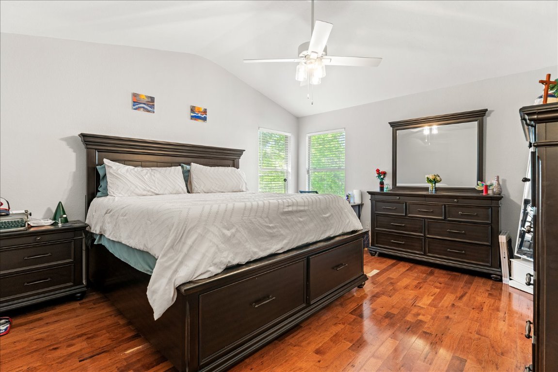 4456 Mather Kyle, TX 78640 - Photo 11 of 25 Bedroom with lofted ceiling, dark wood-style floors, and a ceiling fan