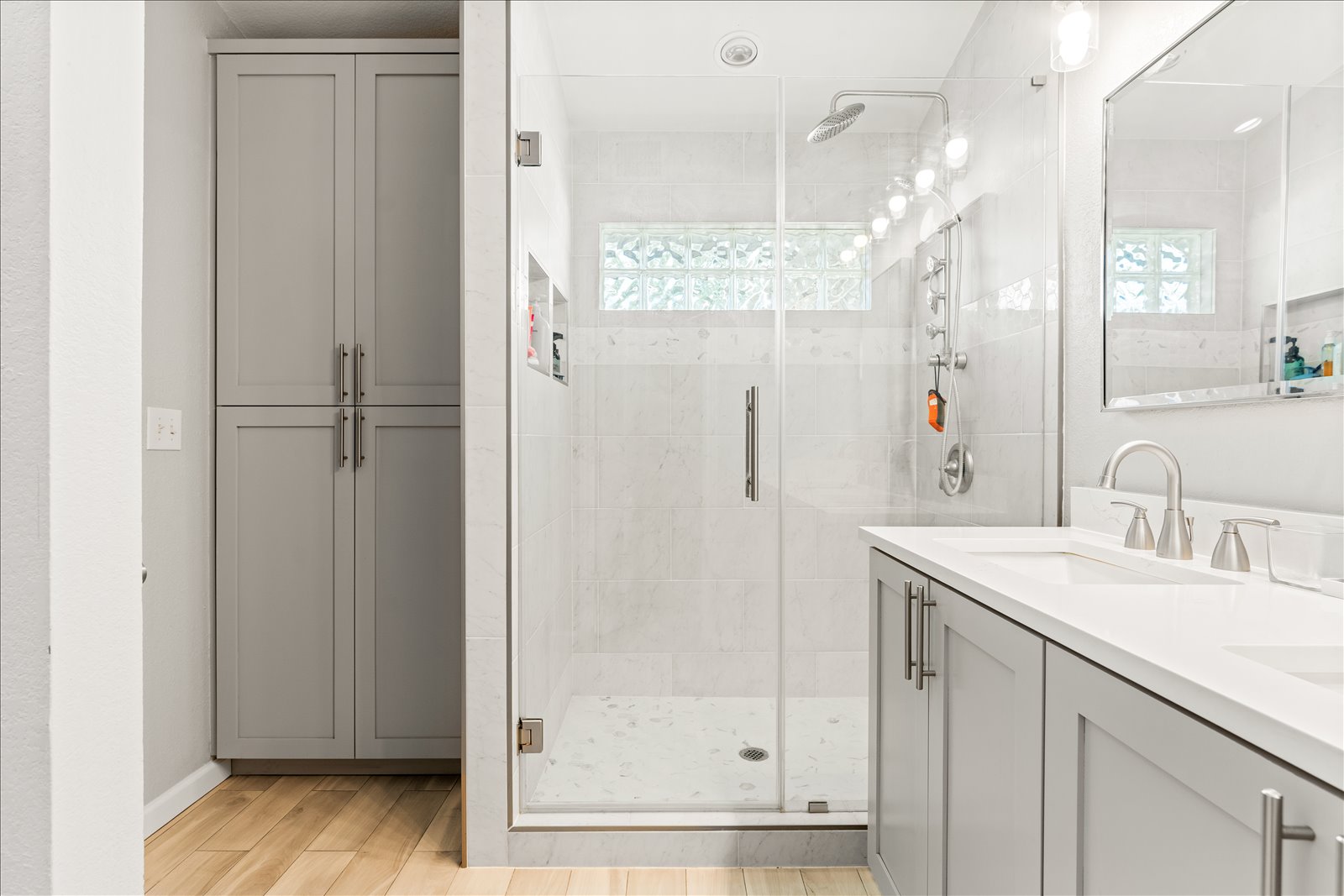 4456 Mather Kyle, TX 78640 - Photo 15 of 25 Full bath featuring double vanity, healthy amount of natural light, a stall shower, and wood finish floors