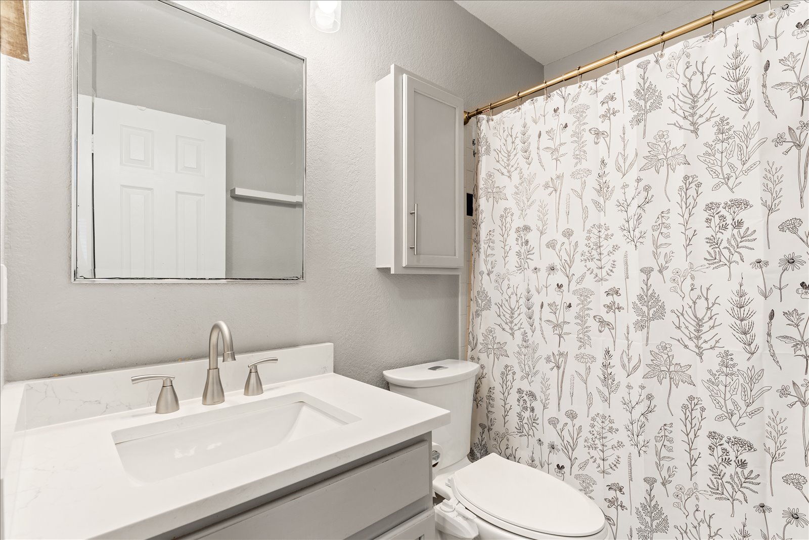 4456 Mather Kyle, TX 78640 - Photo 17 of 25 Full bath with a textured wall, vanity, and a shower with shower curtain