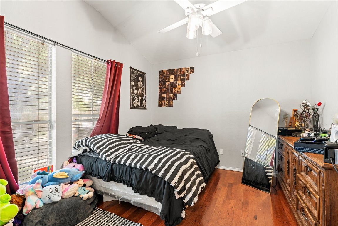 4456 Mather Kyle, TX 78640 - Photo 19 of 25 Bedroom featuring vaulted ceiling, dark wood-style flooring, and a ceiling fan