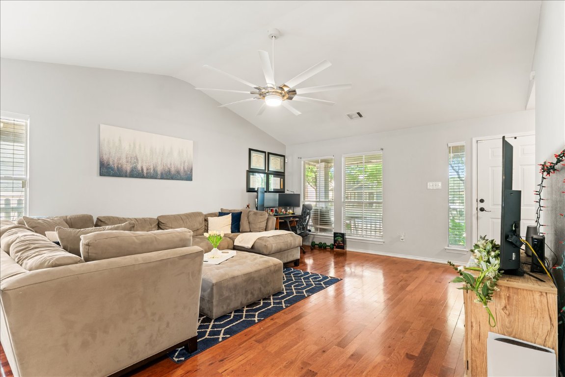 4456 Mather Kyle, TX 78640 - Photo 6 of 25 Living area with lofted ceiling, a ceiling fan, hardwood / wood-style flooring, and a desk