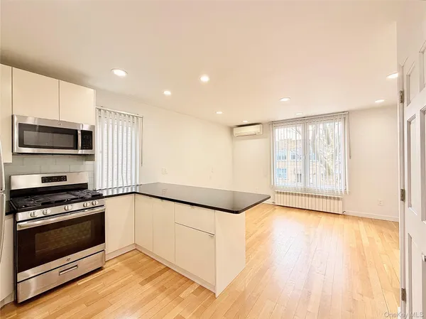 a view of a kitchen with a stove top oven