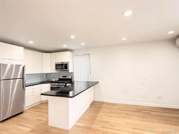 a kitchen with stainless steel appliances a refrigerator and a stove top oven