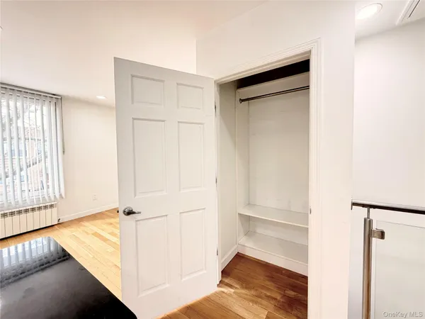 a view of walk in closet with empty room