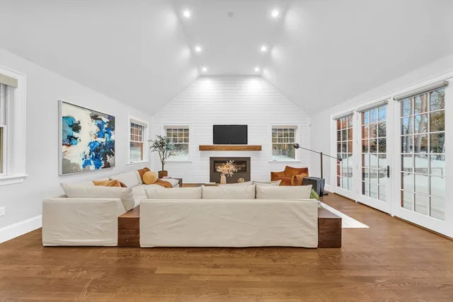 a living room with fireplace furniture and a flat screen tv