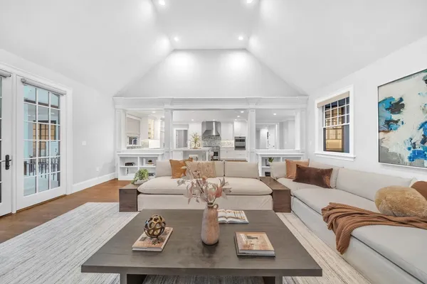 a living room with furniture couches and a large window