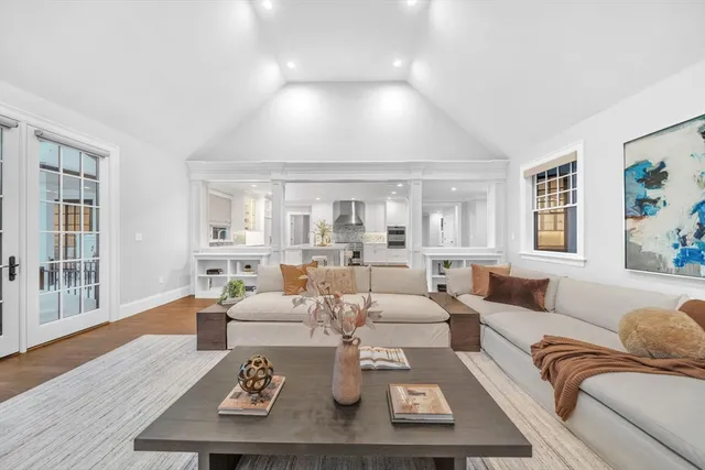 a living room with furniture couches and a large window