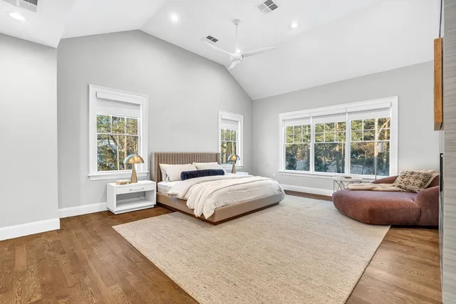 a spacious bedroom with a large bed and a couch