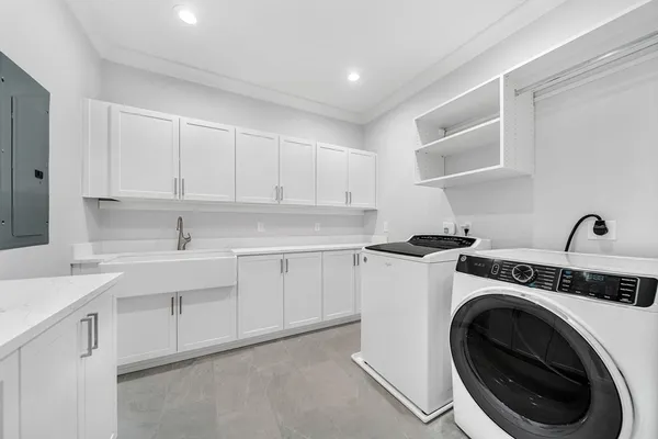 a view of a kitchen with sink washer and dryer