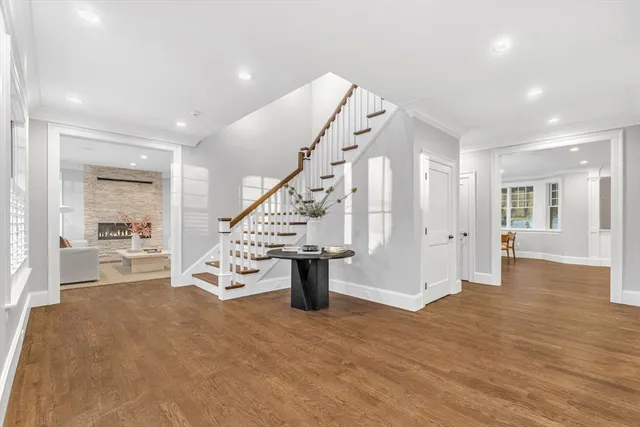 a view of an entryway with wooden floor and a living room