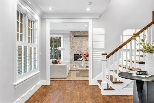 a view of an entryway with wooden floor and windows