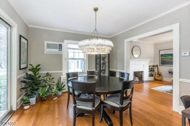 a dining room with furniture potted plants and wooden floor