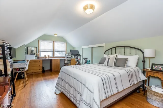 a bedroom with two beds and a large window