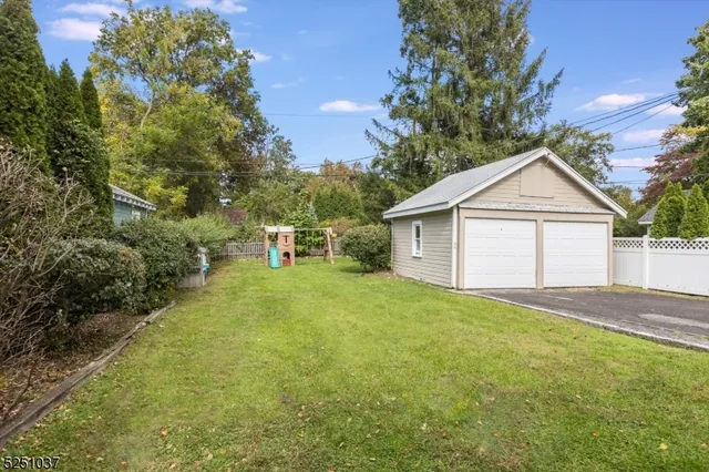 a front view of a house with a garden and yard