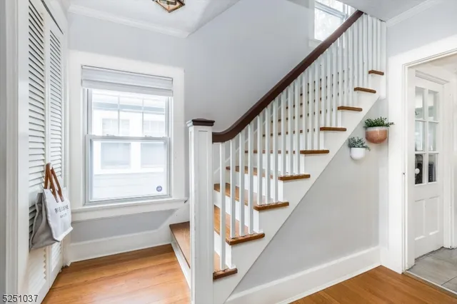 a view of entryway with wooden floor and stairs