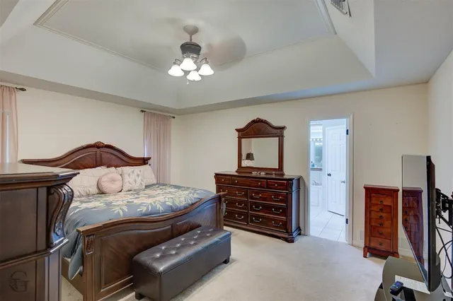 a bedroom with a bed and dresser