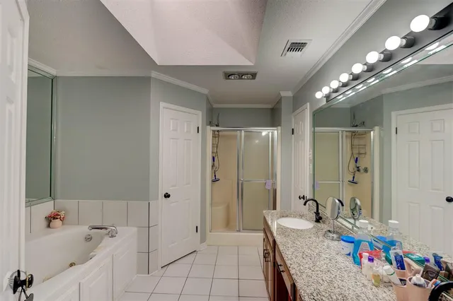 a bathroom with a tub shower and sink