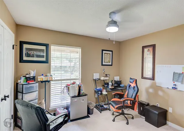 a work room with furniture and a window