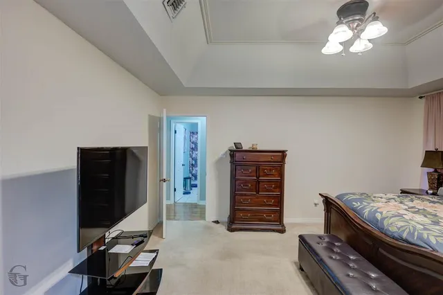a bedroom with furniture and a flat screen tv
