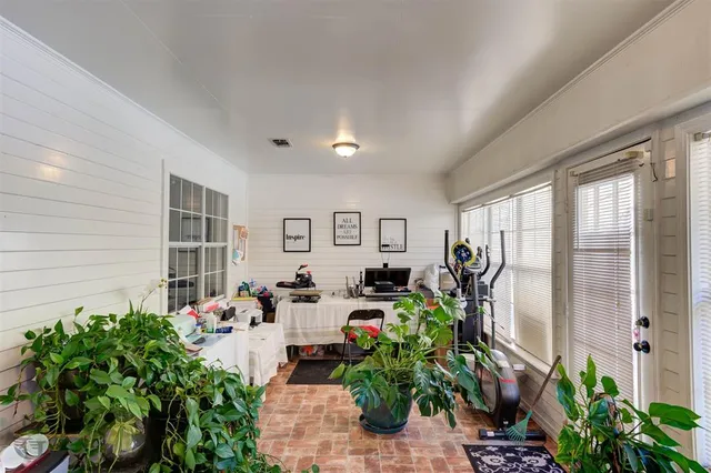 a living room with furniture potted plant and windows