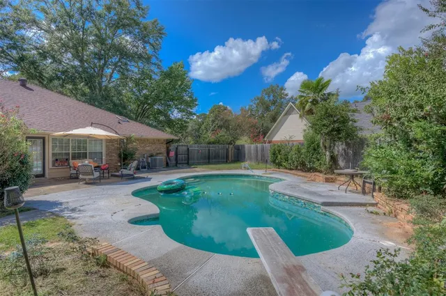 a view of a house with backyard porch and sitting area