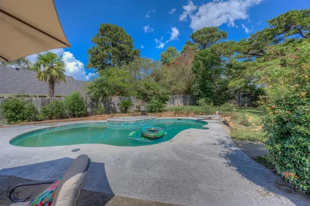 a view of a garden with a swimming pool