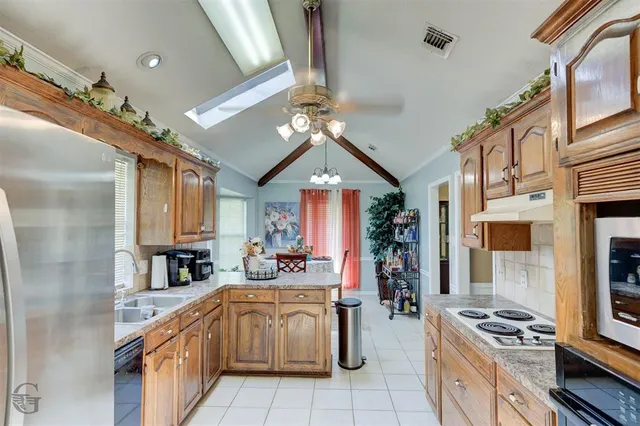 a kitchen with stainless steel appliances granite countertop a stove and a sink