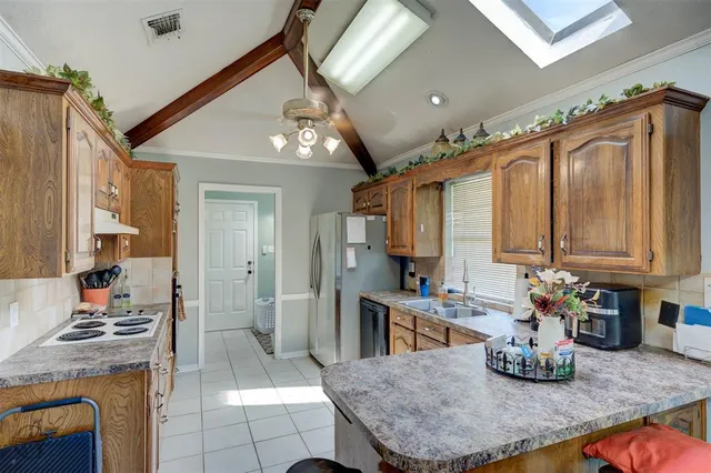 a kitchen with a stove a sink and a refrigerator