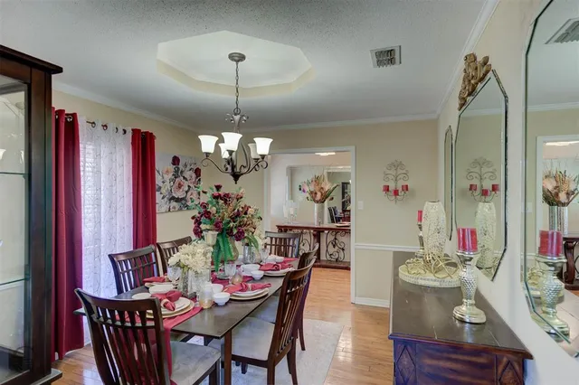 a view of a dining room with furniture and chandelier
