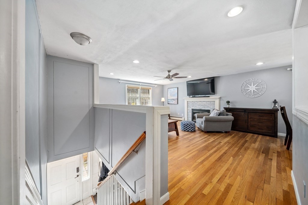 9 Bailey Lane Georgetown, MA 01833 - Photo 11 of 42 a living room with furniture and a wooden floor