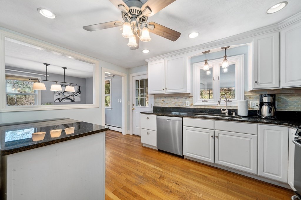 9 Bailey Lane Georgetown, MA 01833 - Photo 12 of 42 a large kitchen with stainless steel appliances granite countertop a lot of counter space and wooden floor