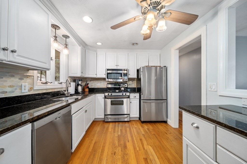 9 Bailey Lane Georgetown, MA 01833 - Photo 14 of 42 a kitchen with a sink stainless steel appliances and cabinets